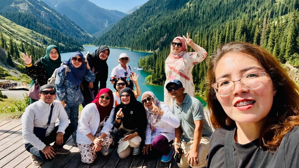 Happy group selfie with local guide at Kolsai Lake Kazakhstan — Kyrgyz Vibes Central Asia tour