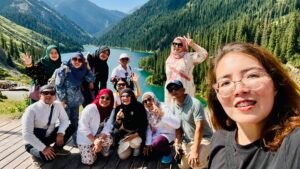 Happy group selfie with local guide at Kolsai Lake Kazakhstan, Kyrgyz Vibes Central Asia tour